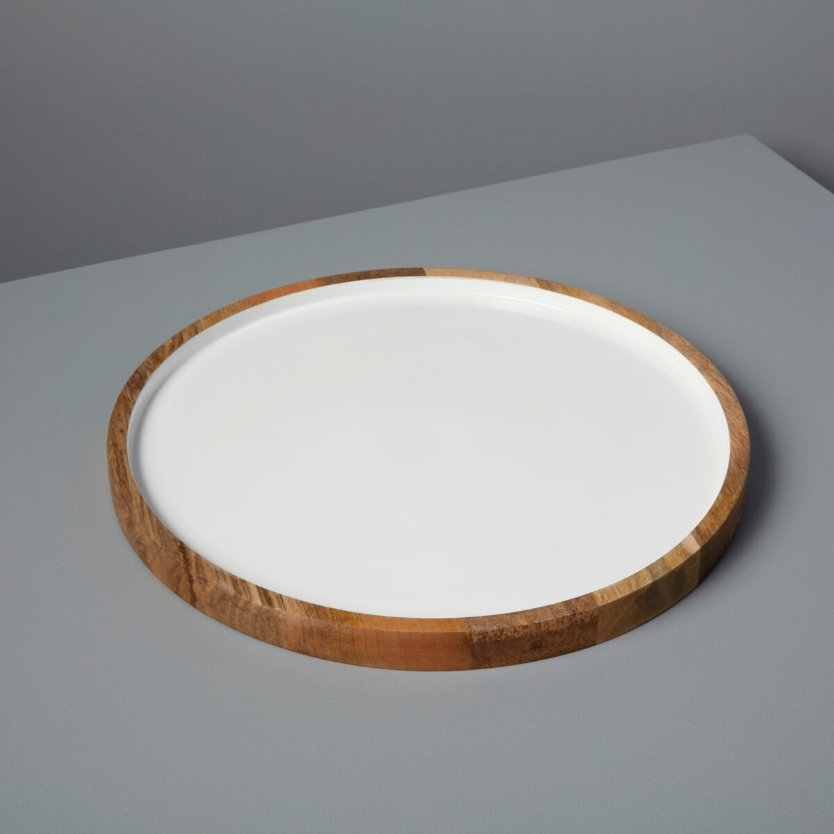 Élégance naturelle à table avec notre assiette de présentation ronde en bois de manguier et émail blanc. Mettez en valeur vos plats avec style et authenticité